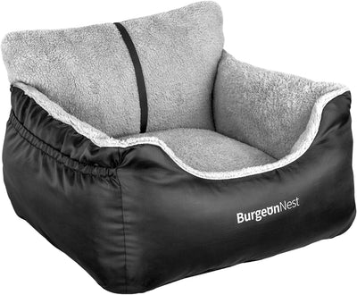 Small dog resting inside padded black car booster seat