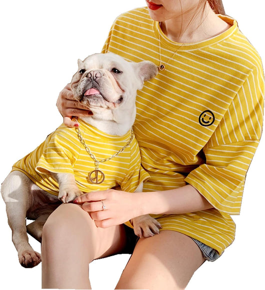 happy dog owner wearing yellow striped matching shirt with dog