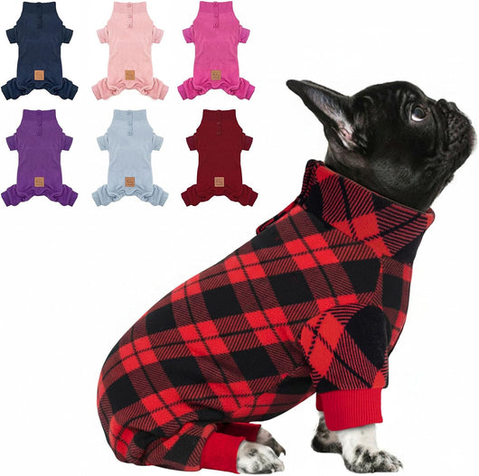 Black French Bulldog wearing red and black buffalo plaid four-leg fleece dog pajamas with a high collar and red cuffs.