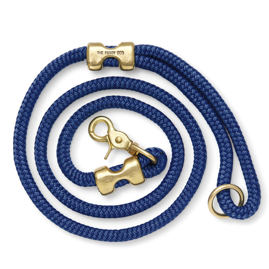 Ocean blue braided nylon dog leash coiled on a white background with gold-tone clasp, end clamps, and accessory ring.